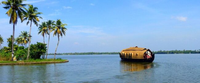 A luxury private Alleppey boathouse setting sail from the Punnamada jetty at 12 PM noon for an overnight cruise through the Kerala backwaters.