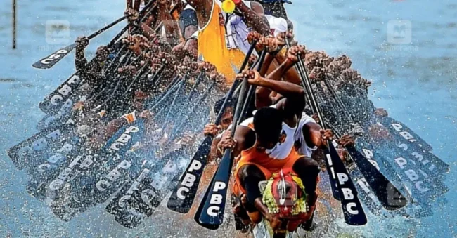 A premium double deck Alleppey boathouse anchored on Punnamada Lake watching the Nehru Trophy Snake Boat Race during Onam season in Kerala India.
