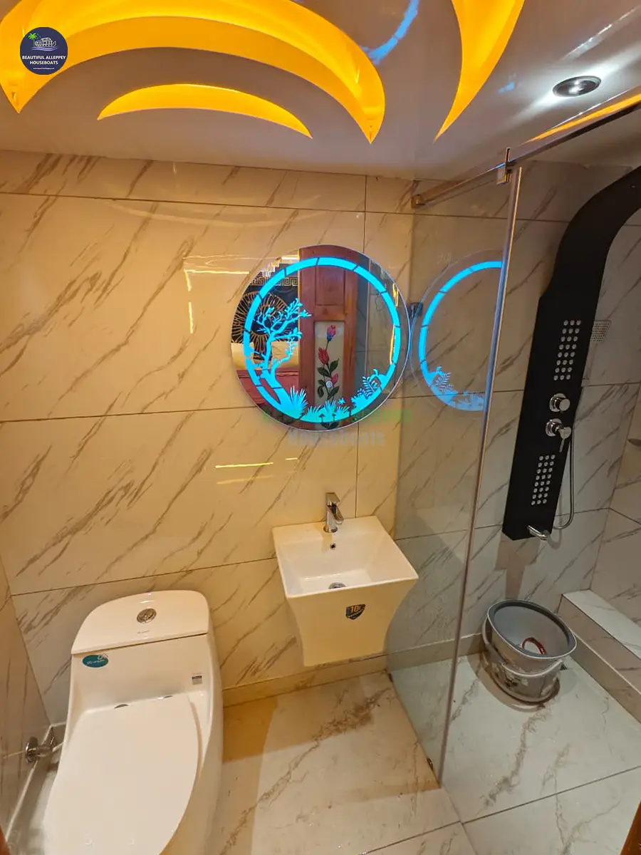 Modern Houseboat En-Suite Bathroom Clean, modern en-suite bathroom with luxury fixtures inside a premium Alleppey houseboat