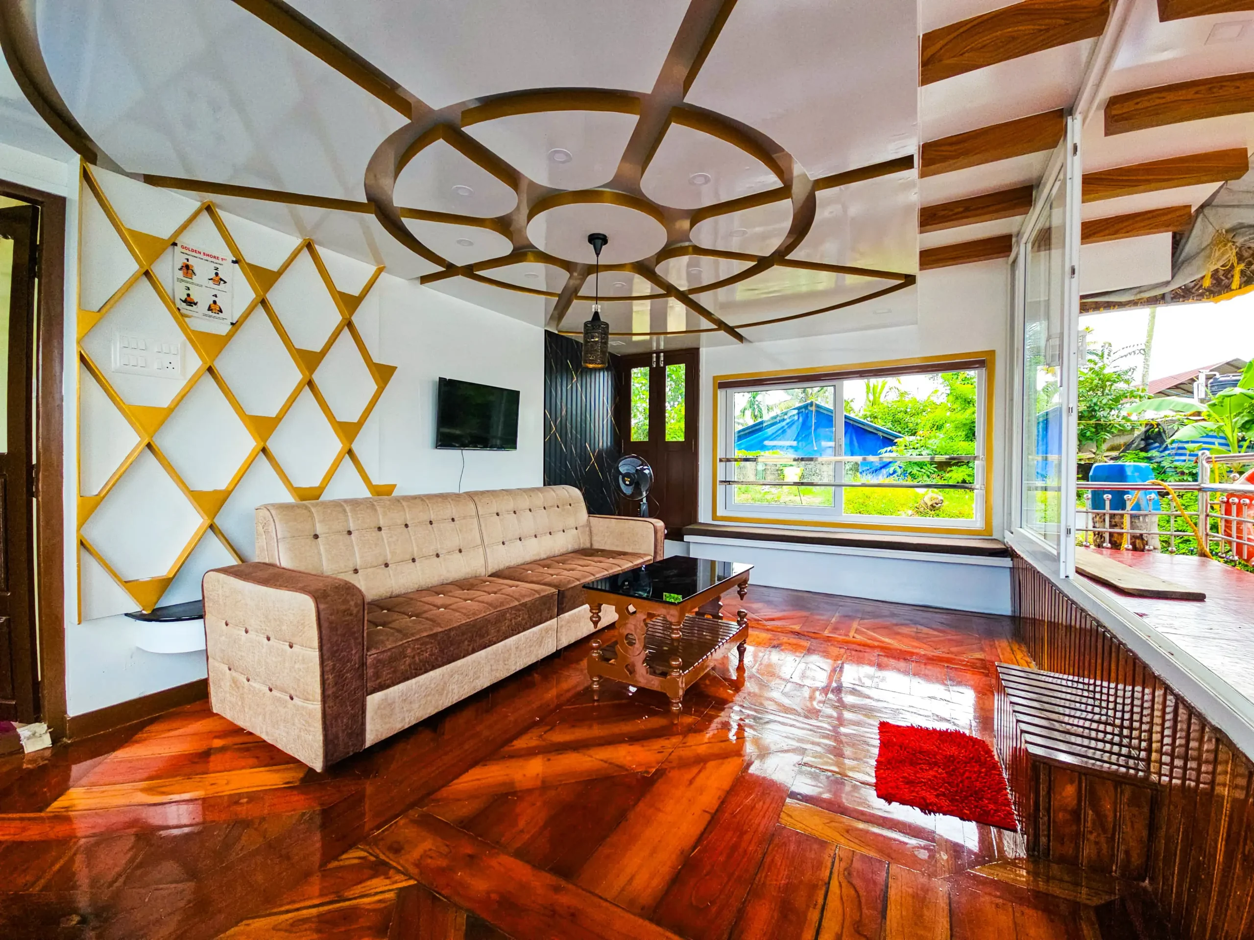 Side view of the glass-enclosed front lounge showing wooden floors, wall decor, and driving console.