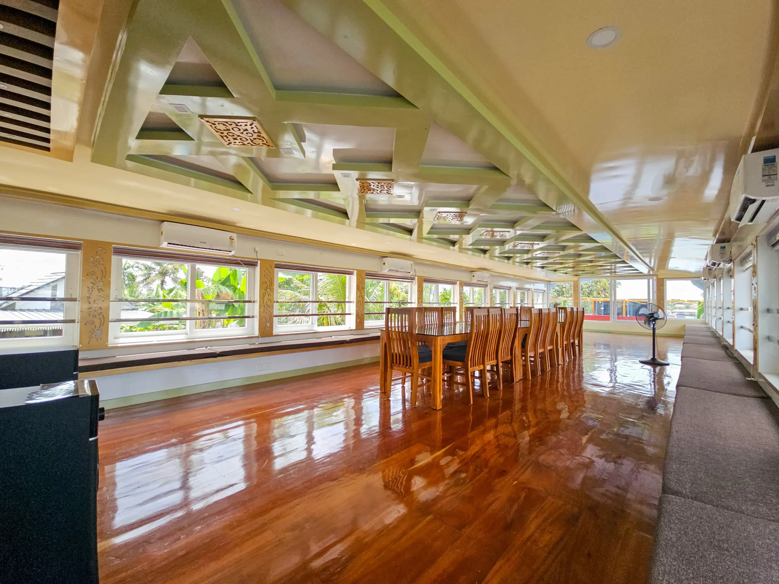 Expansive Full Upper Deck Hall – 4 Bedroom Premium Houseboat Long glass-enclosed full upper deck hall with polished wooden floorboards and continuous side windows.