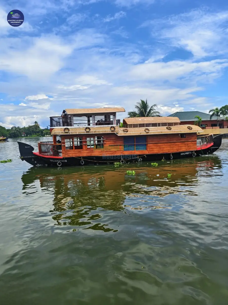 Exterior view of a premium 1-bedroom glass-covered houseboat cruising on Alleppey backwaters