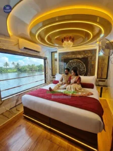 Warmly lit A/C bedroom with wooden paneling and plush bedding on a luxury honeymoon houseboat