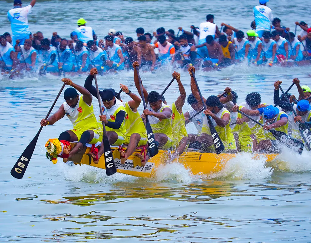 Fierce competition during the Nehru Trophy Boat Race on Punnamada Lake in Alappuzha, Kerala, featuring traditional Chundan Vallams or snake boats with rows of oarsmen splashing water
