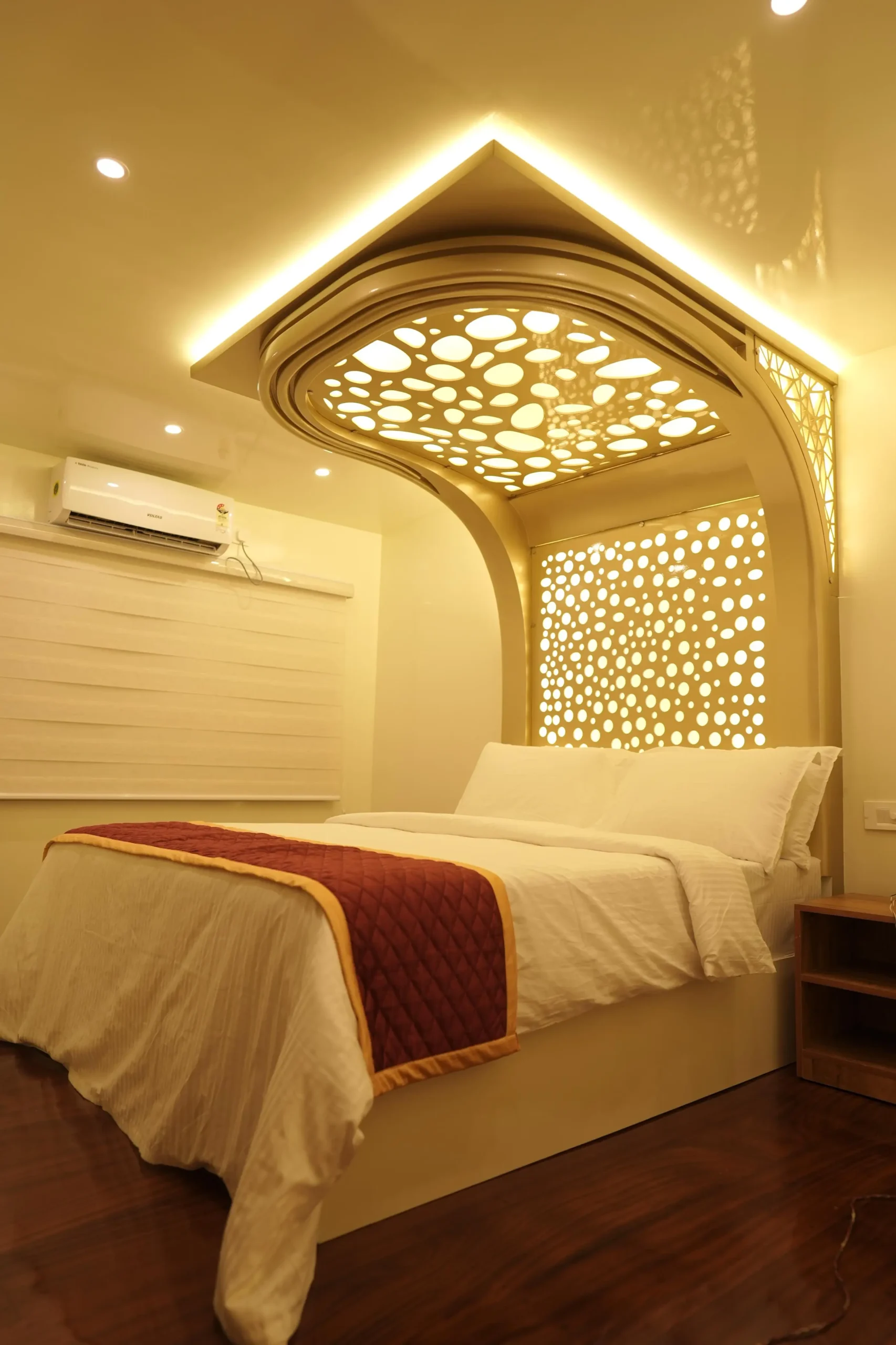 Luxury AC Bedroom Suite with Royal Blue Accent Wall – Houseboat Air-conditioned houseboat bedroom decorated with a royal blue padded headboard, blue ceiling accents, and a large side window.