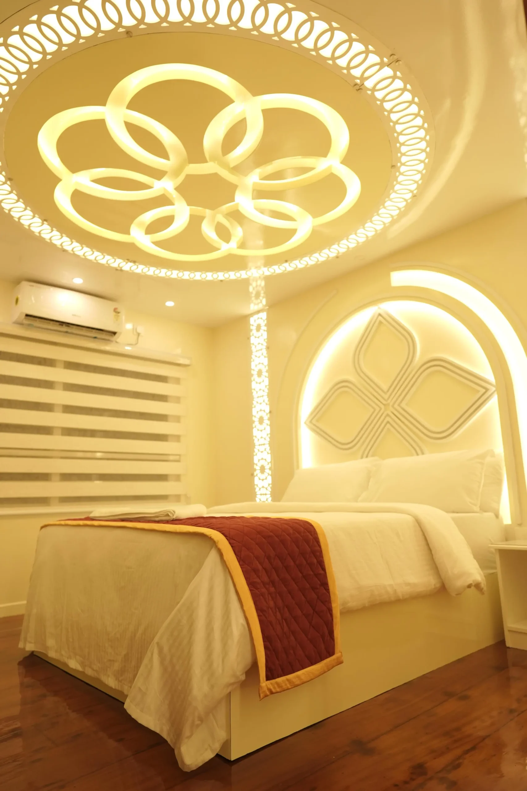 AC Bedroom with Large Backwater View Window Premium air-conditioned bedroom inside a 5 bedroom houseboat with a tall beige padded headboard and scenic side window.